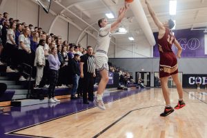 Zach Ingle shots a three-pointer against Coe on December 14 in Mount Vernon.