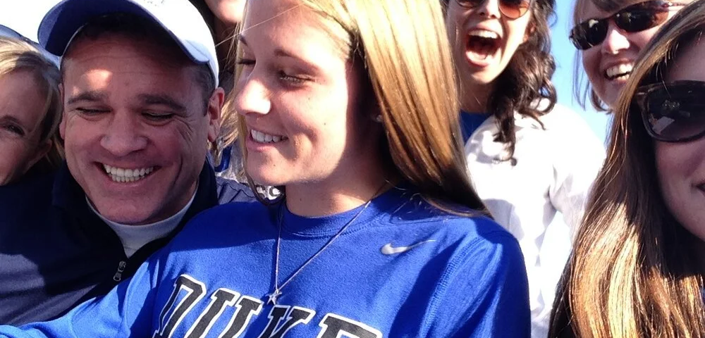 Picture of Morgan surrounded by family as she is signing her letter of commitment to play lacrosse at Duke University.