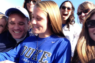 Picture of Morgan surrounded by family as she is signing her letter of commitment to play lacrosse at Duke University.