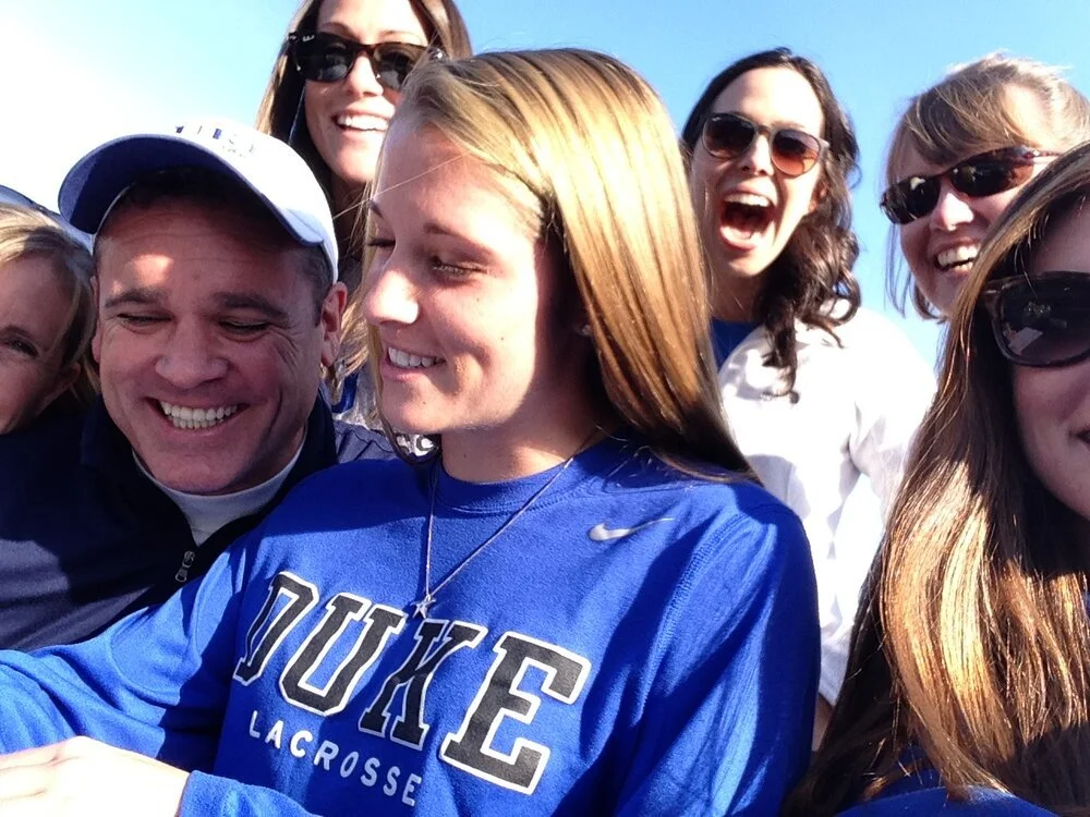 Picture of Morgan surrounded by family as she is signing her letter of commitment to play lacrosse at Duke University.