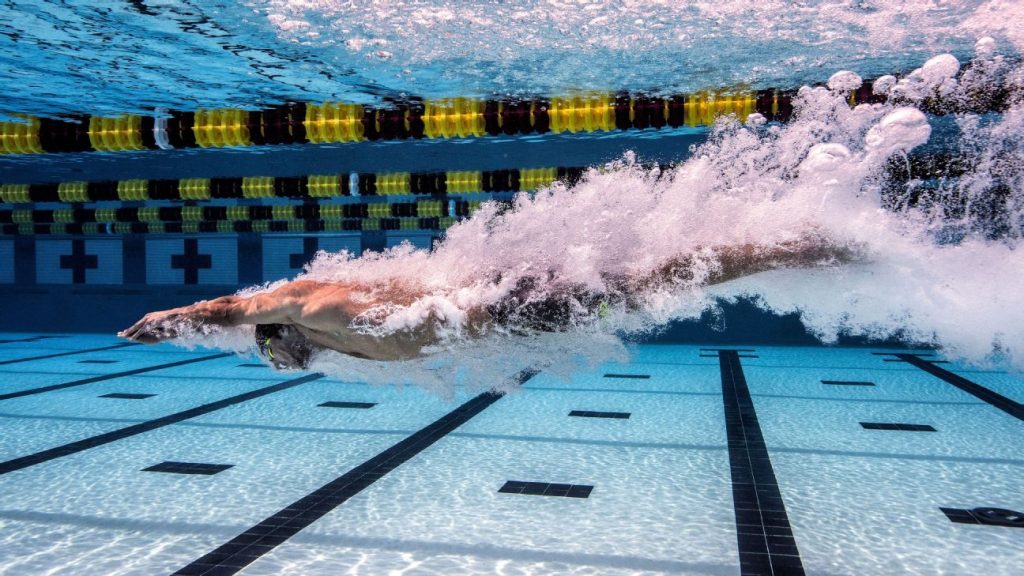 Michael Phelps underwater after diving into the pool.