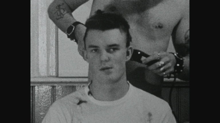 Screenshot of "No Skin Off my Ass" that depicts a man getting a haircut by another shirtless man